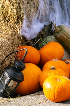 A Spooky Still Life with a Lantern and Spiderwebs. Concept The atmosphere of Halloween night. photo