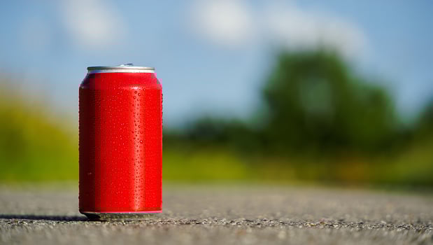 Refreshing red soda can on a sunny day outdoors photo