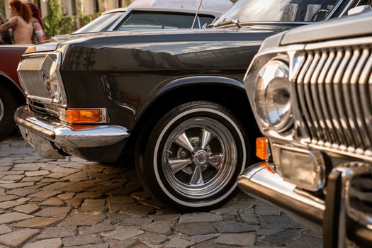 Classic Cars Parked on Cobblestone Street photo