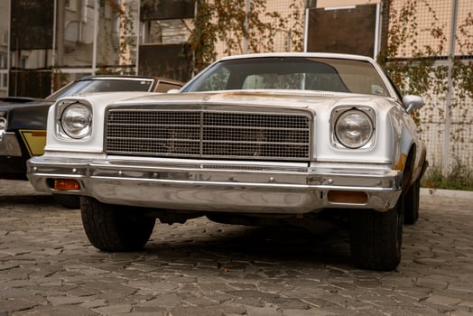 Classic Vintage Car Parked on Cobblestone Street photo