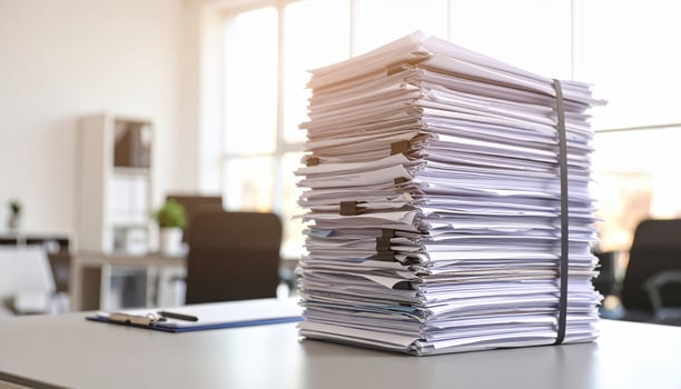 Towering mountain of paperwork creates chaotic symphony of documents in modern office setting, reflecting overwhelming nature of administrative tasks and responsibilities photo