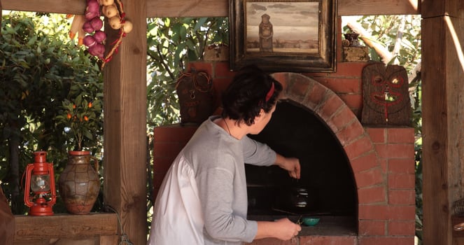Cooking process in rustic oven surrounded by charming decor, traditional setting, showcasing culinary skills and warmth, evoking nostalgia and connection to heritage photo