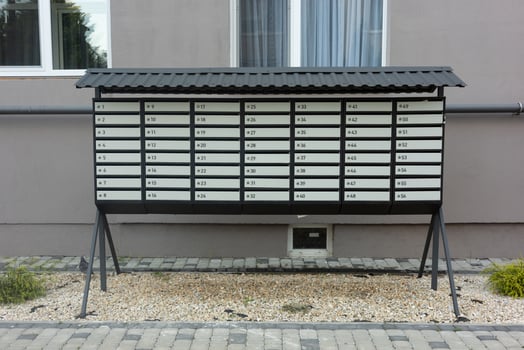 A neat, organized row of mailboxes outside an apartment building, ready for deliveries. photo