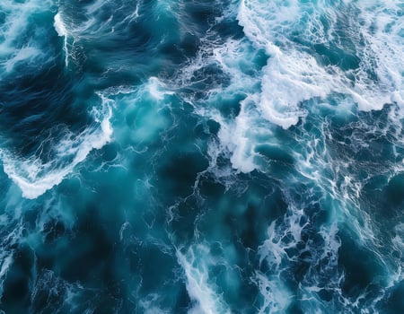 aerial view of the ocean with powerful, frothy waves crashing, revealing stunning patterns and textures in deep blue and turquoise hues. photo