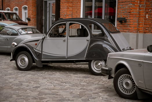 Vintage Cars Parked on Cobblestone Street photo