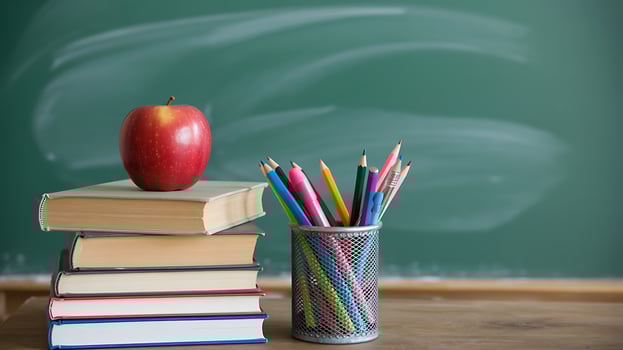 Red apple books pencils classroom learning education school supplies photo