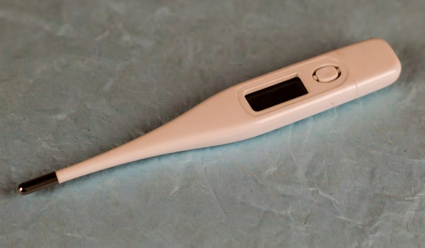 Electronic Thermometer Lying on a Textured Background photo