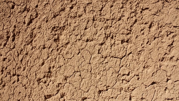 A close up of a brown wall with cracks photo