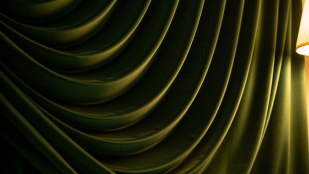 A green curtain with a lamp on top of it photo
