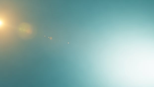 A bright light shining through a foggy sky photo