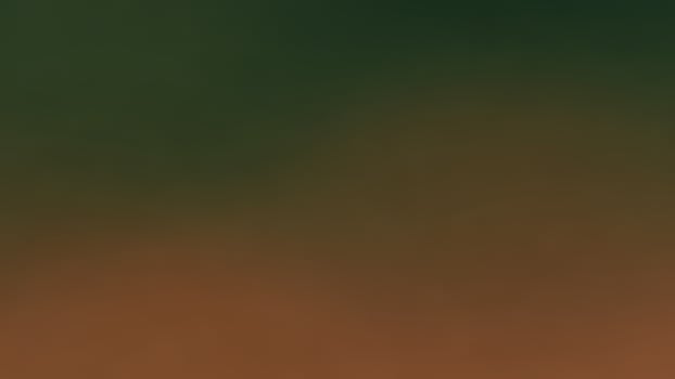 A blurry image of a bird flying over a green field photo