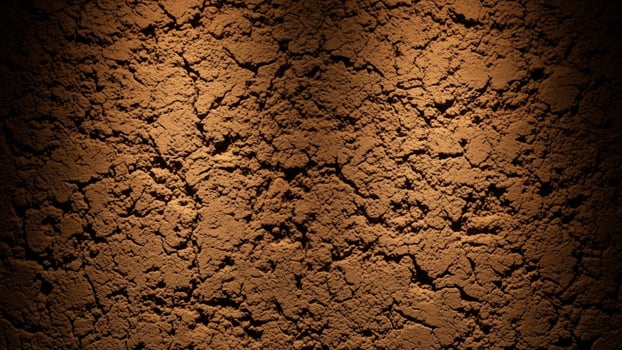 A brown dirt background with some dirt on it photo