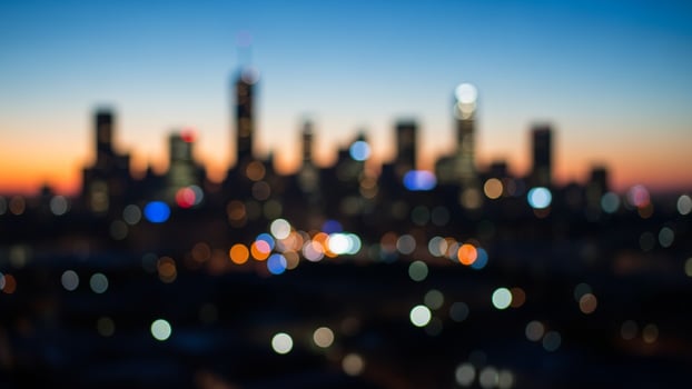 Blurred cityscape at dusk with lights and buildings photo