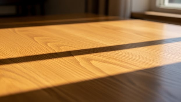 A wooden table with sunlight coming through the window photo