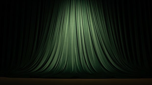 Green curtain with light coming from behind it photo