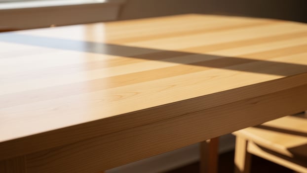 A wooden table with a chair and a window photo