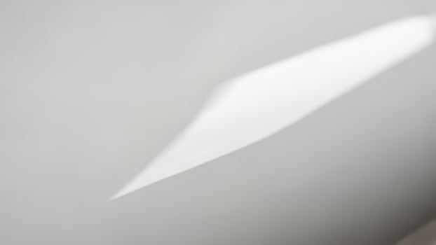 A white wall with a white light shining on it photo