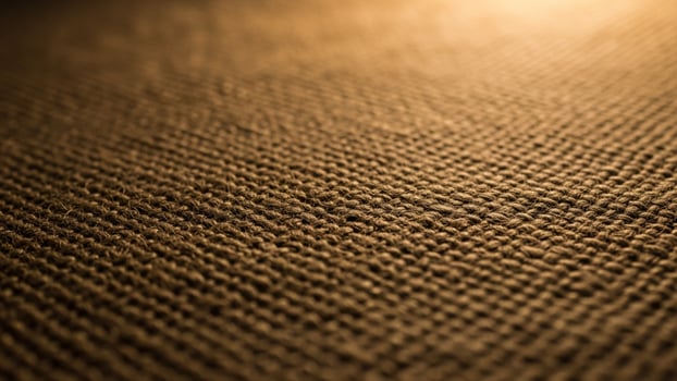 A close up of a brown fabric with a light shining through photo