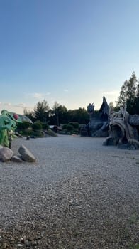 A large rock sculpture with a dinosaur on top photo