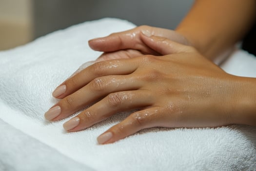 A person is getting their hands washed with a towel photo