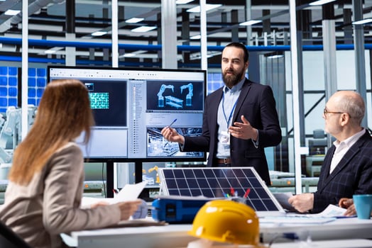 Photovoltaics factory executives planning strategic investment decisions, going over data. Investor and solar panels factory management team standing together discussing business data photo