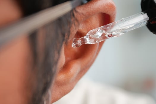 Applying ear drops for ear health and comfort photo