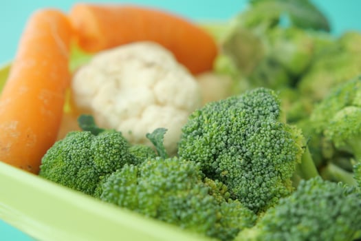 Fresh vegetables arranged in a colorful serving container photo