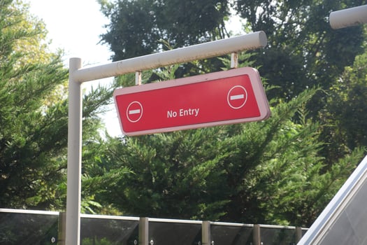 Sign indicating restricted access in park area photo