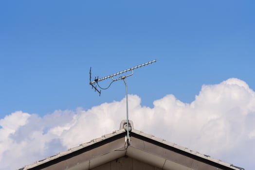 TV Antenna Installed on house rooftop. photo
