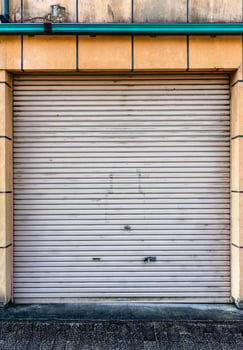 Closed steel shutter door of warehouse, storefront for metal door background and textured. photo