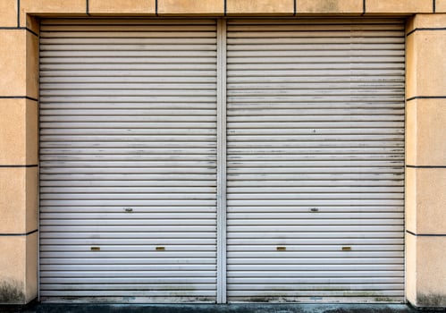 Closed steel door of warehouse, storage or storefront for metal door background and textured. photo