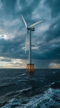 Majestic offshore wind turbine stands tall against a dramatic stormy sky photo
