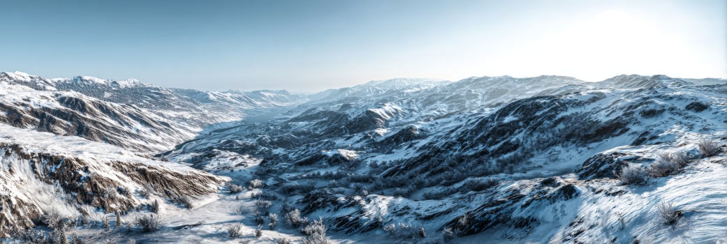 Snow-covered mountain landscape under bright blue sky showcasing vast icy terrain and distant peaks with soft light photo