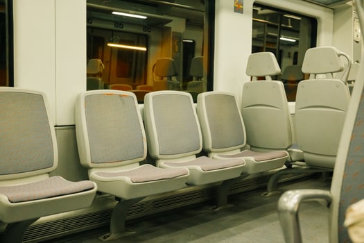 Empty train interior with gray seats at night photo