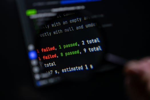 Dark computer screen displays programming test results showing 'failed' and 'passed' counts, symbolizing software development, debugging, and quality assurance photo