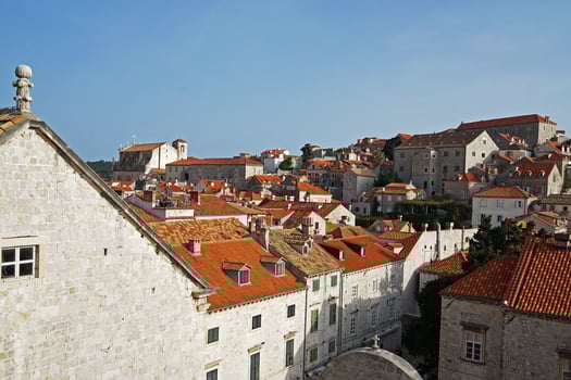Exterior European architecture and design decoration of Dubrovnik old town city walls and landscape with clear blue sky, southern Croatia fronting the Adriatic sea encircled with massive stone photo