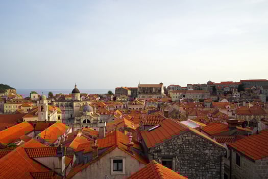 Exterior European architecture and aerial design of Dubrovnik old town city walls and landscape with clear blue sky, southern Croatia fronting the Adriatic sea encircled with massive stone photo