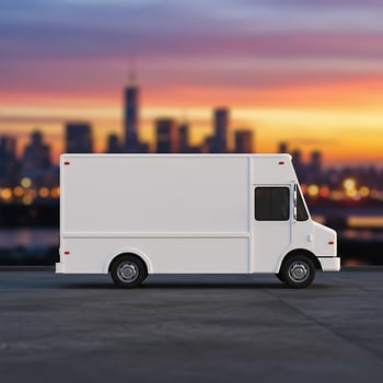 White delivery truck with city skyline in background photo