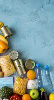 A variety of food items including cans, bottles, and vegetables photo
