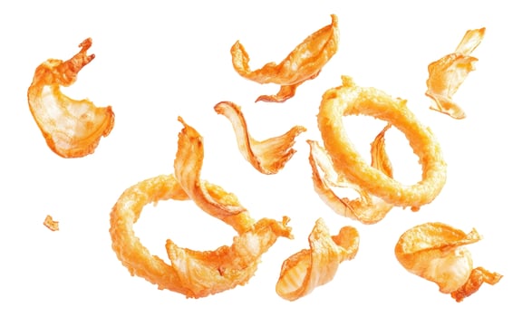 Crispy Golden Fried Onion Rings and Pieces Floating on White Background photo