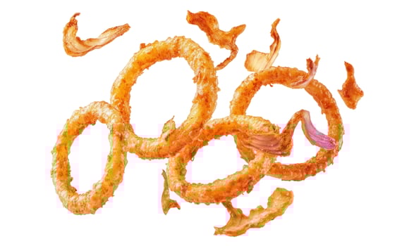 Delicious crispy golden onion rings and fried pieces floating on white. photo