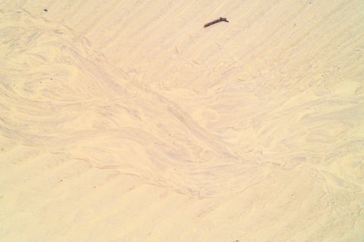 A natural abstract background of wet sand after the tide. Beach patterns. photo