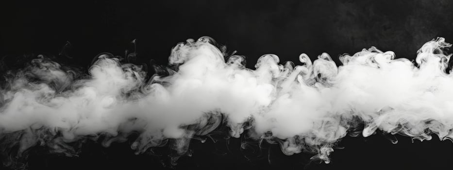 A long white cloud of smoke is billowing out of a pipe photo