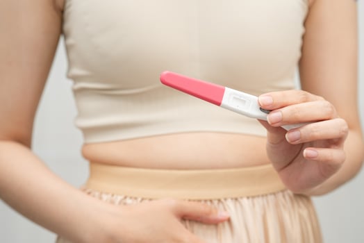 Asian holding pregnancy test for female of ovulation day, fetus, maternity photo