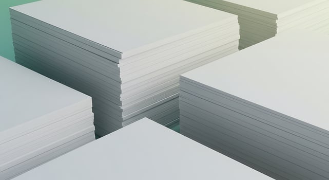 A stack of white paper on a green background photo