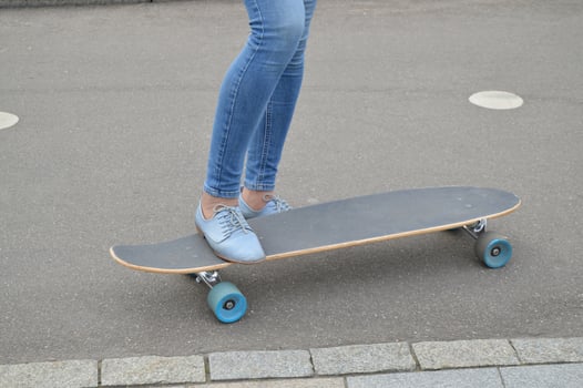 skateboarder, skateboarding female feet in the skatepark photo