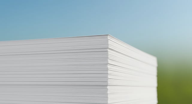 Stack of white paper on a green background photo