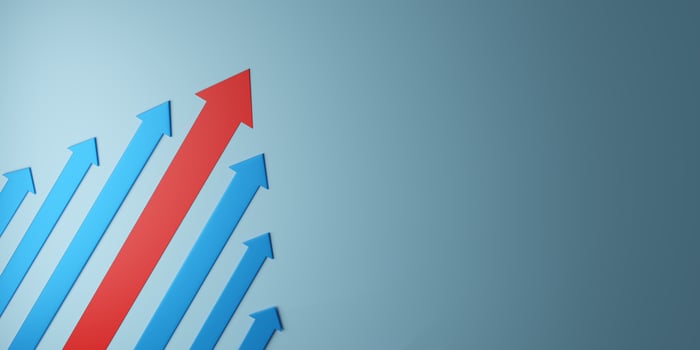 3D illustration of a red arrow leading blue arrows upward, symbolizing leadership, growth, success, teamwork, and market dominance. Ideal for business and finance concepts. photo