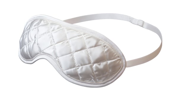 Quilted White Satin Sleep Mask with Adjustable Strap on White Background photo