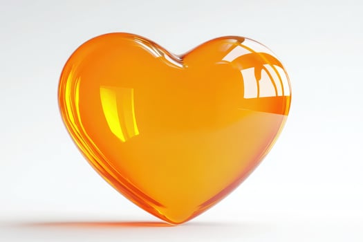 Orange glass heart isolated on white background photo